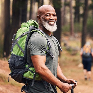 Senior man smiling on hiking trail