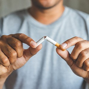 Closeup of patient breaking cigarette