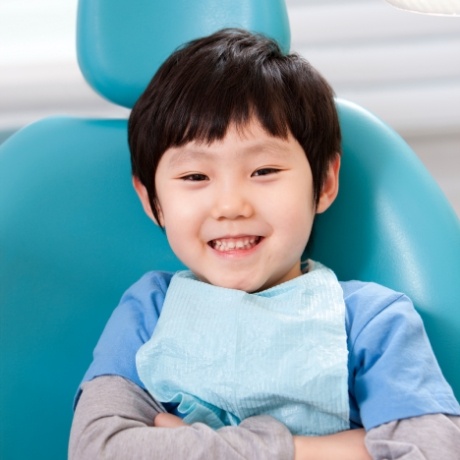 Young child smiling in dental chair