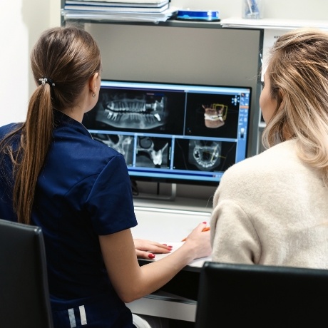 Dentist showing patient x rays of their teeth