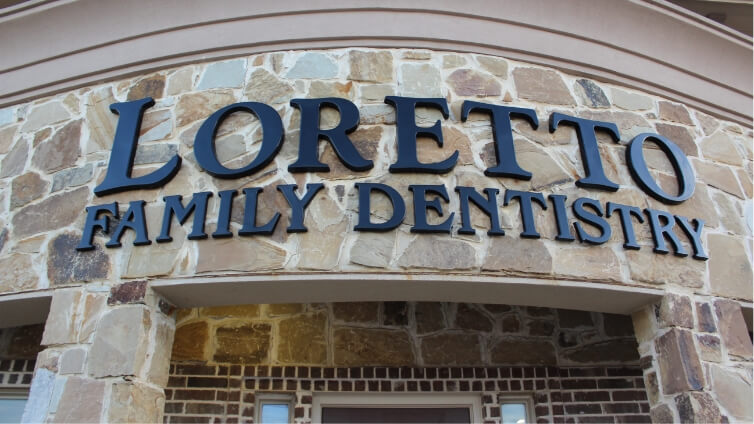 Loretto Family Dentistry sign on front of Corinth dental office building